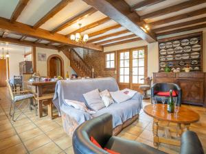 een woonkamer met een bank en een tafel bij Holiday Home Pors Ar Goff - PNG102 by Interhome in Plouégat-Guérand
