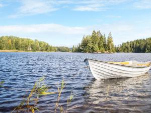 a white boat sitting on a large body of water at Chalet Långban - VMD233 by Interhome in Filipstad