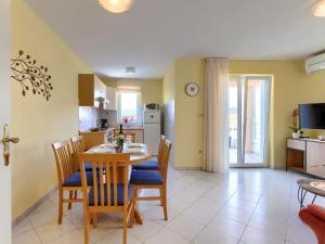 a kitchen and dining room with a table and chairs at Apartment Egle by Interhome in Rabac