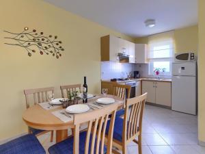a kitchen with a wooden table with chairs and a dining room at Apartment Egle by Interhome in Rabac