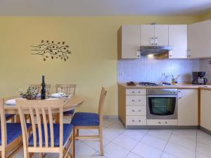 a kitchen with a table and a dining room at Apartment Egle by Interhome in Rabac