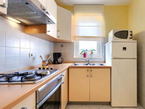 a kitchen with a white refrigerator and a sink at Apartment Egle by Interhome in Rabac +30 photos