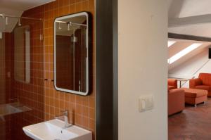 a bathroom with a sink and a mirror at Pension Merano in Jetřichovice