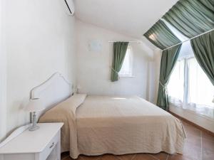 Habitación blanca con cama y ventana en Apartment Winery Villa Vitas Dépendance - App-1 by Interhome, en Strassoldo