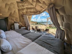 a bedroom with two beds and a large window at 8POINT RESORT Okinawa in Nanjo