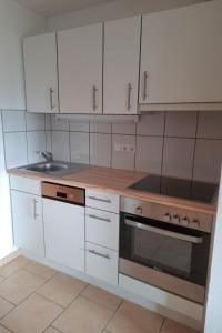 a kitchen with white cabinets and a sink at Apartment Corinna by Interhome in Vandans