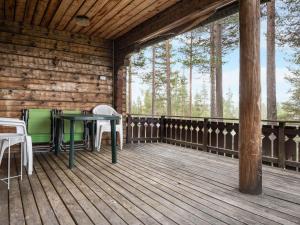 a wooden deck with a table and chairs on it at Chalet Lofsdalen Furan by Interhome in Lofsdalen