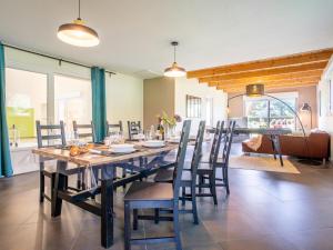 uma sala de jantar com uma grande mesa de madeira e cadeiras em Holiday Home Villa Heol by Interhome em Plouégat-Guérand
