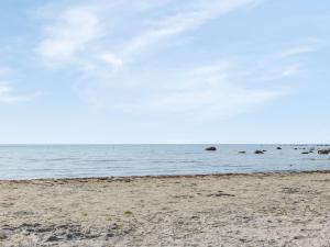 a sandy beach with the ocean in the background at Holiday Home Västra Näs - B in Sölvesborg