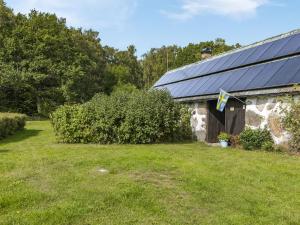 a house with a solar roof on a yard at Holiday Home Västra Näs - B in Sölvesborg