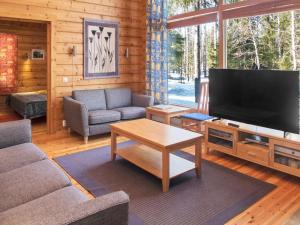 a living room with a large flat screen tv at Holiday Home Villa rukaherttua by Interhome in Ruka