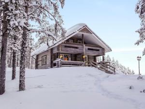 una cabaña de madera en el bosque en la nieve en Holiday Home Ylikyrön mökki by Interhome, en Kyrö