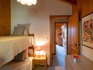 a bedroom with a bed and a table with a lamp at Apartment Licorne 13 by Interhome in Verbier