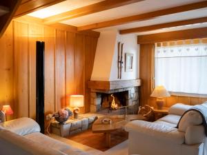 a living room with a fireplace and couches at Apartment Licorne 13 by Interhome in Verbier