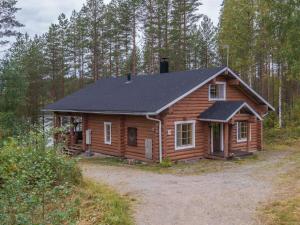 a log cabin in the middle of a forest at Holiday Home Mäntyrinne by Interhome in Ruottila