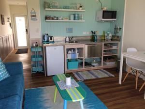 a living room with a kitchen and a table at Leigh Central in Leigh