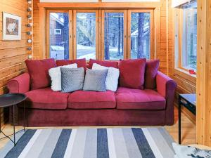 a purple couch with pillows on it in a room at Holiday Home Levinstone by Interhome in Sirkka