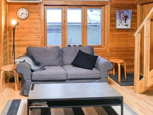 a living room with a couch and a table at Holiday Home Levinstone by Interhome in Sirkka