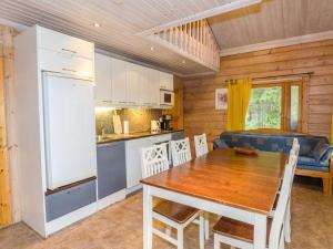 a kitchen and dining room with a table and a refrigerator at Holiday Home Marski by Interhome in Kolinkylä