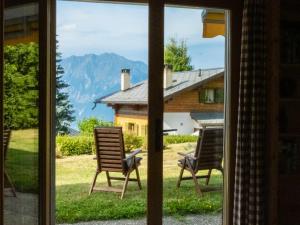 a view of two chairs from a window at Apartment Baroudeur B04 by Interhome in Verbier
