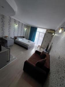 sala de estar con sofá y cama en Orbi Sea Towers Batumi, en Batumi
