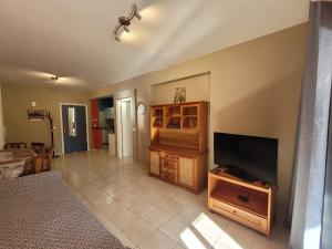a living room with a flat screen tv at Limnaria Gardens Paphos, near beach in Paphos