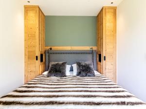 a bedroom with a bed with two pillows at Apartment Les Cimes - Le Lac by Interhome in Tignes