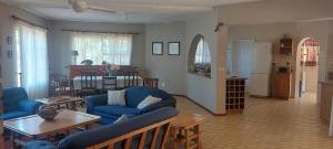 a living room with a blue couch and a table at Cycasia Lodge in Umzumbe