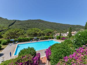 a view of a swimming pool with mountains in the background at Apartment Terrazza Cala Rossa by Interhome in Nisporto