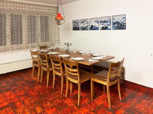 a dining room with a wooden table and chairs at Apartment Fifinhaus by Interhome in Fiesch