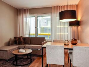 a living room with a couch and a table at Holiday Home Levin kunkku b5 by Interhome in Levi