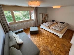 a living room with two beds and a couch at Apartment Alte Gasse 9 by Interhome in Engelberg