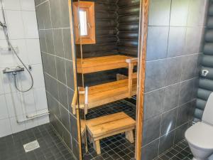 a bathroom with a shower with a toilet and stairs at Holiday Home Aamunkoin rantatupa by Interhome in Pyhäsalmi