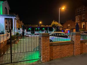 a fence in front of a street at night at Southport Metro Hotel in Southport