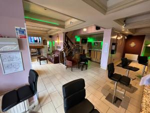 a waiting room with chairs and a barber shop at Southport Metro Hotel in Southport