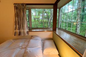Voodi või voodid majutusasutuse Windy hill 森の宿 toas