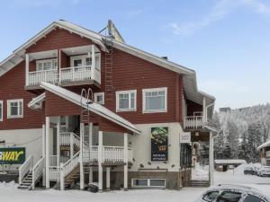 a large wooden house in the snow at Holiday Home Keskuskuja b4 by Interhome in Sirkka