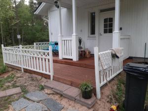 a porch with a white fence on a house at Holiday Home Huvikumpu by Interhome in Hailuoto