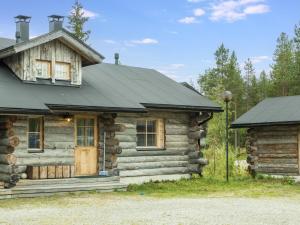 a log cabin with a black roof at Holiday Home Lauri 2 by Interhome in Sirkka