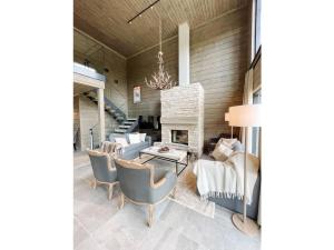 a living room with a table and chairs and a fireplace at Holiday Home Willa levi west a by Interhome in Sirkka