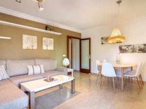 a living room with a couch and a table at Apartment Nice 4 You by Interhome in Port d'Alcudia