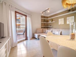 a living room with a table and a couch at Apartment Nice 4 You by Interhome in Port d'Alcudia