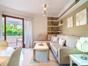 a living room with a couch and a table at Apartment Nice 4 You by Interhome in Port d'Alcudia