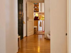 una puerta abierta a una cocina con suelo de madera dura en Laxmi Happy Home in historical Prague, en Praga