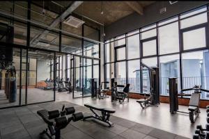 a gym with treadmills and exercise equipment and windows at KL Minimalist Muji Style 3R2B in Kuala Lumpur