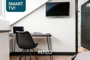 una scrivania con sedia e una TV appesa a un muro di Cosy Studio Apartment in Derby by Renzo, Ideal for Contractors and Business Stays a Derby