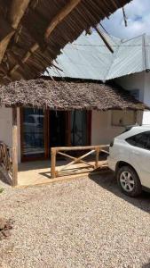 a white car parked in front of a house at Bhome Zanzibar in Kiwengwa