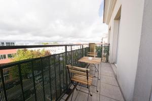 a balcony with two chairs and a table on it at Le Libération - Paris Disney - 2 min gare in Bussy-Saint-Georges