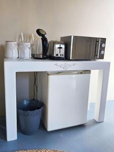 a white table with a microwave on top of it at Best Place Ever in Hout Bay