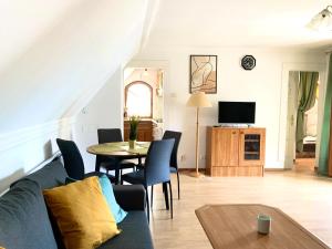 a living room with a couch and a table at Heviz Gracia Apartment in Hévíz